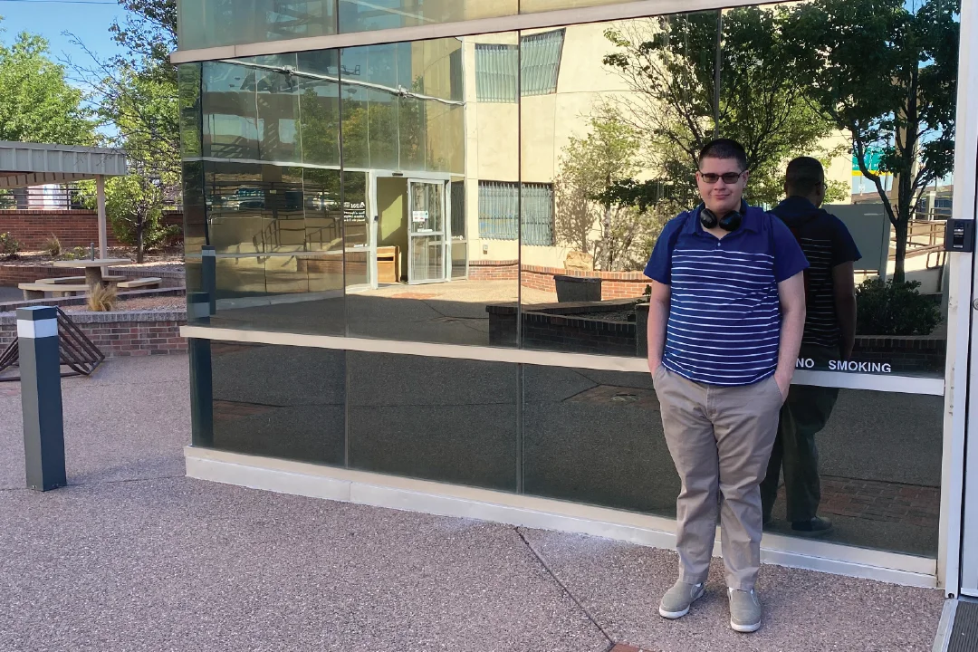 Success story subject smiling with headphones over his shoulders