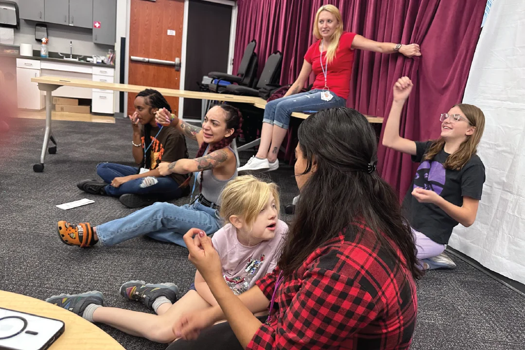 happy camp group sitting together in discussion